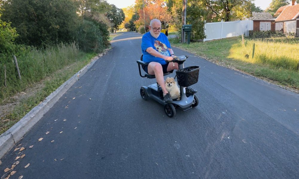 Elderly people driving electric scooters on the road