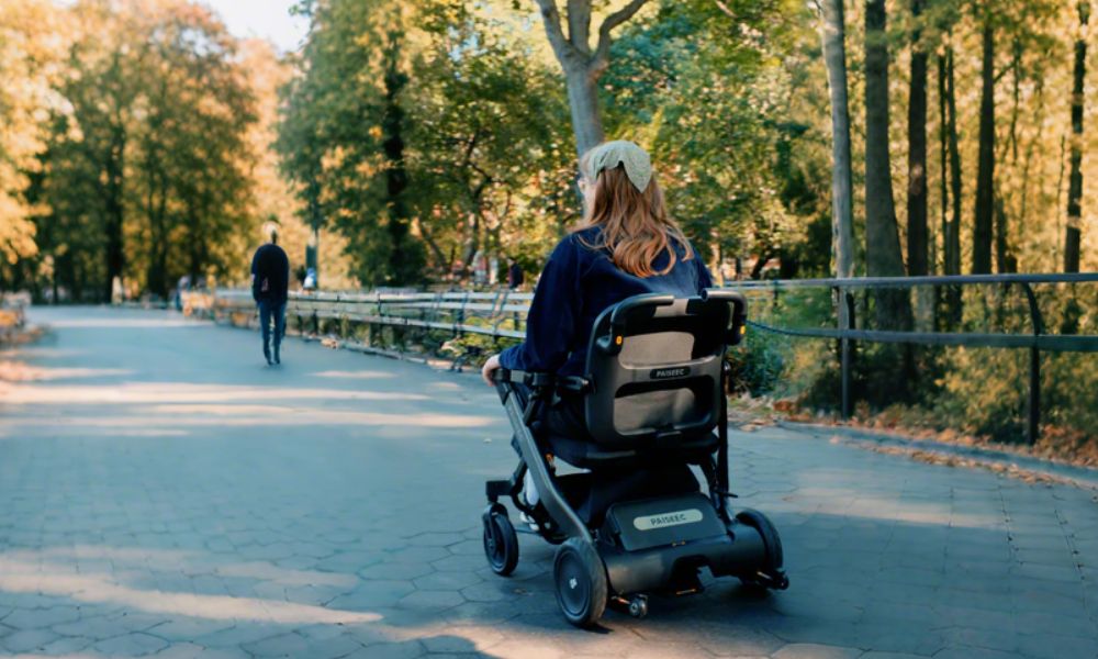 Woman driving electric wheelchair on the road