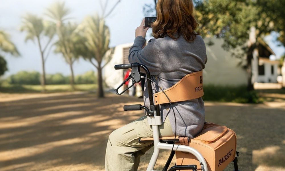 Woman taking photo while sitting on 4-wheel roller walker