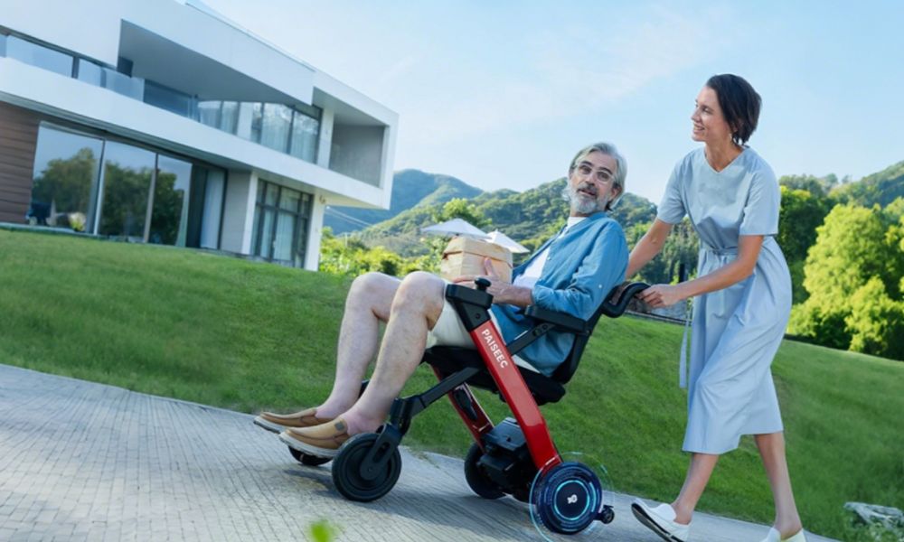 Family pushes electric wheelchair