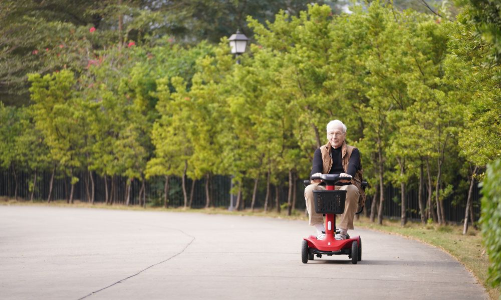 Elderly people driving a mobility scooter outdoors